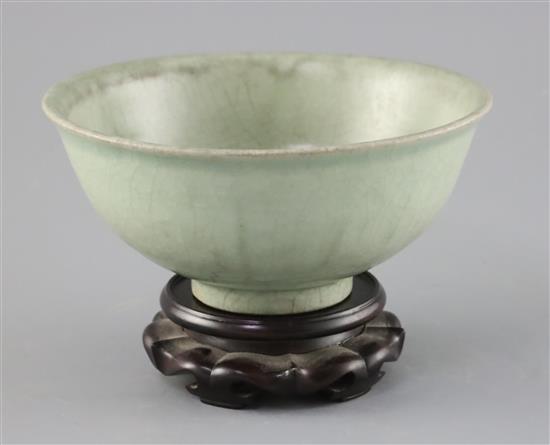 A Chinese Longquan celadon bowl, Ming dynasty, D. 18.5cm, crackle to glaze, wood stand